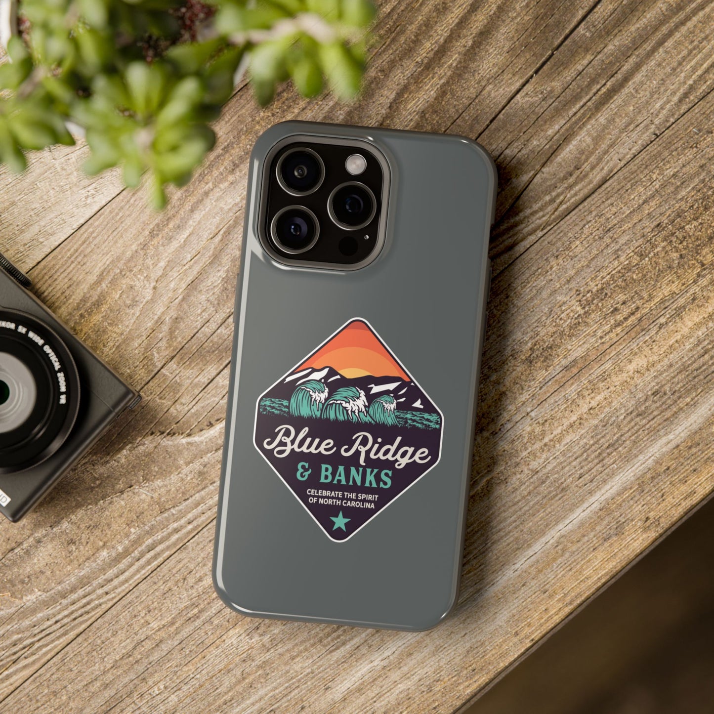 "Blue Ridge & Banks - Magnetic Tough Case for iPhone 16 featuring North Carolina-inspired design elements. This durable case showcases a stunning nature motif, drawing inspiration from the majestic Blue Ridge Mountains. Its intricate details and vibrant colors evoke the beauty of North Carolina's landscapes, making it a perfect blend of style and protection for your device."