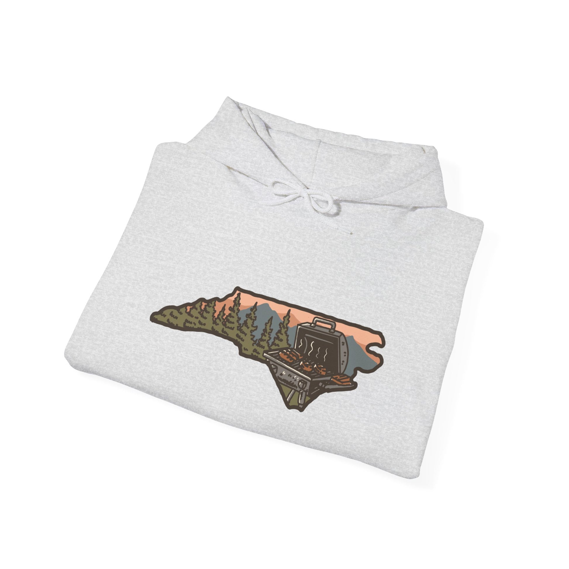 Folded ash gray NC BBQ Mountain Scene hoodie showing chest graphic
