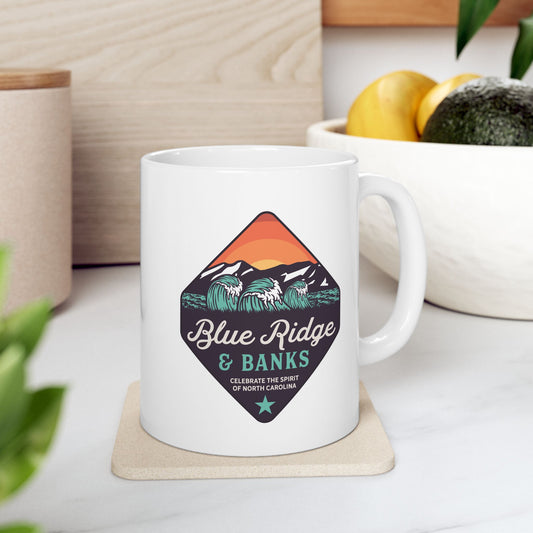 "Blue Ridge & Banks Logo – 11oz Ceramic Mug featuring a sleek and minimalist design. This ceramic mug showcases the iconic Blue Ridge & Banks logo, perfect for coffee enthusiasts and brand fans. Its 11oz size is ideal for a cozy morning brew. The mug's design subtly incorporates elements inspired by North Carolina's natural beauty, capturing the essence of the Blue Ridge Mountains and serene banks. A must-have for nature lovers and those who appreciate quality craftsmanship."