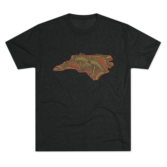 Black t-shirt featuring a vibrant graphic of North Carolina filled with Venus flytraps, printed on the front.