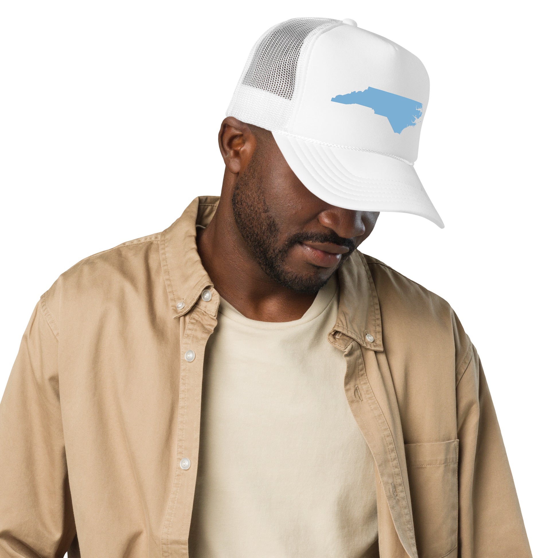 "Stylish Baby Blue NC State Foam Trucker Hat in Classic Black – Featuring a unique North Carolina state shape design, this versatile cap combines comfort and fashion. Perfect for outdoor adventures or casual outings, the hat's breathable foam front and mesh back offer all-day comfort. Embrace the spirit of North Carolina with nature-inspired elements, making it an ideal accessory for fans of the Tar Heel State."