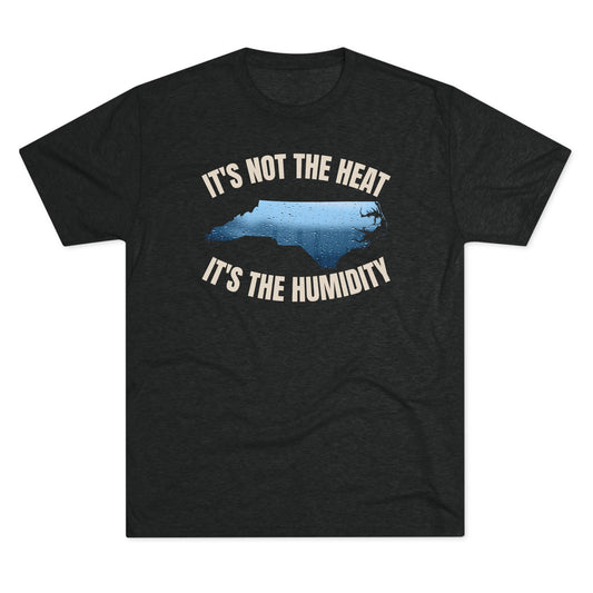 Unisex dark heather t-shirt featuring a water-speckled North Carolina silhouette with the phrase “It’s Not the Heat, It’s the Humidity” in vintage cream text.
