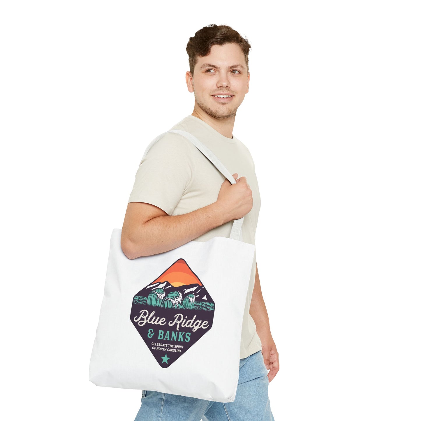 Man carrying Blue Ridge & Banks tote bag featuring North Carolina mountain and wave design