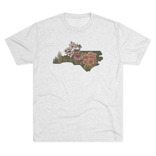 Heather white T-shirt with North Carolina state shape filled with detailed native wildflowers in earthy tones.