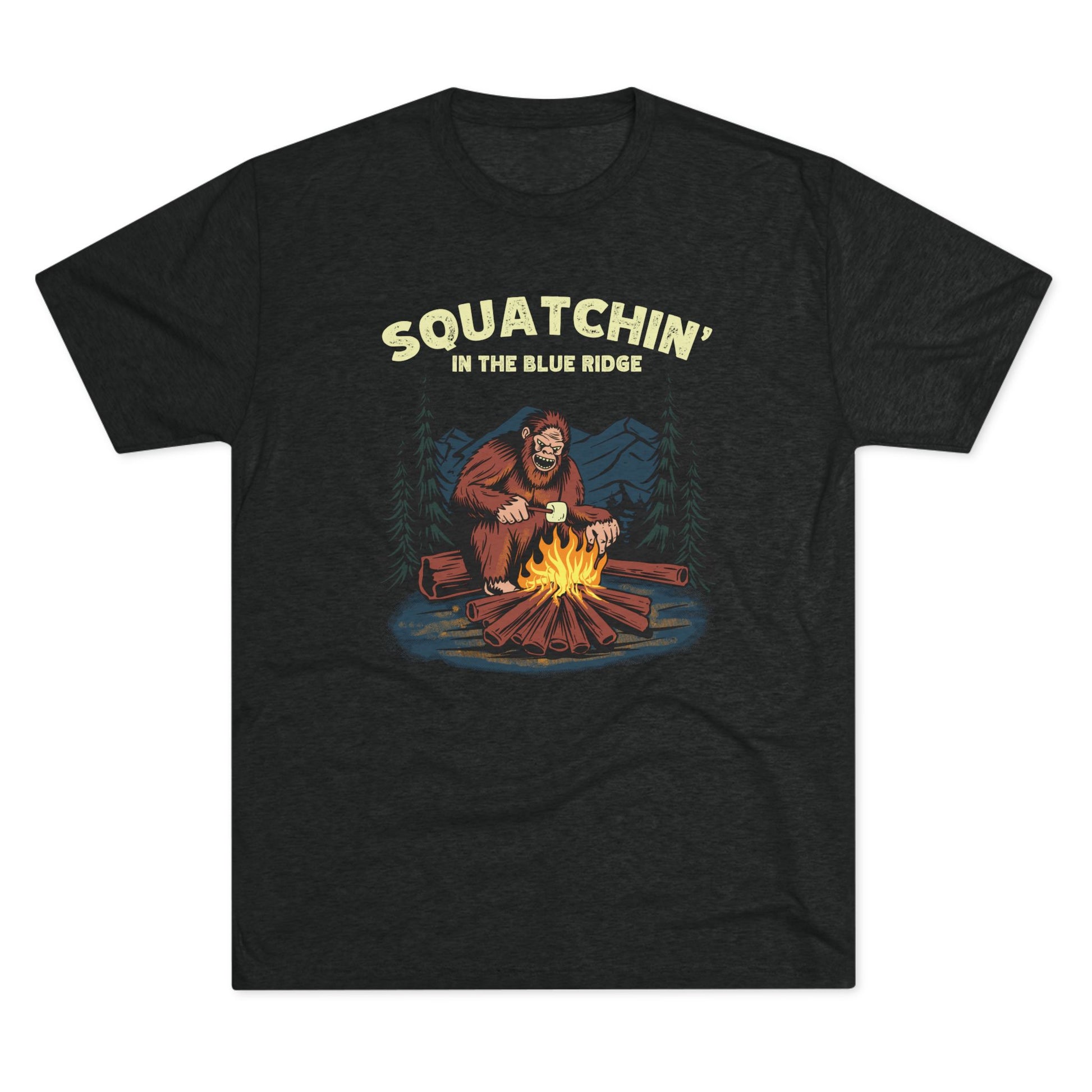 Black t-shirt with a camping Bigfoot roasting marshmallows and "Squatchin' in the Blue Ridge" text.